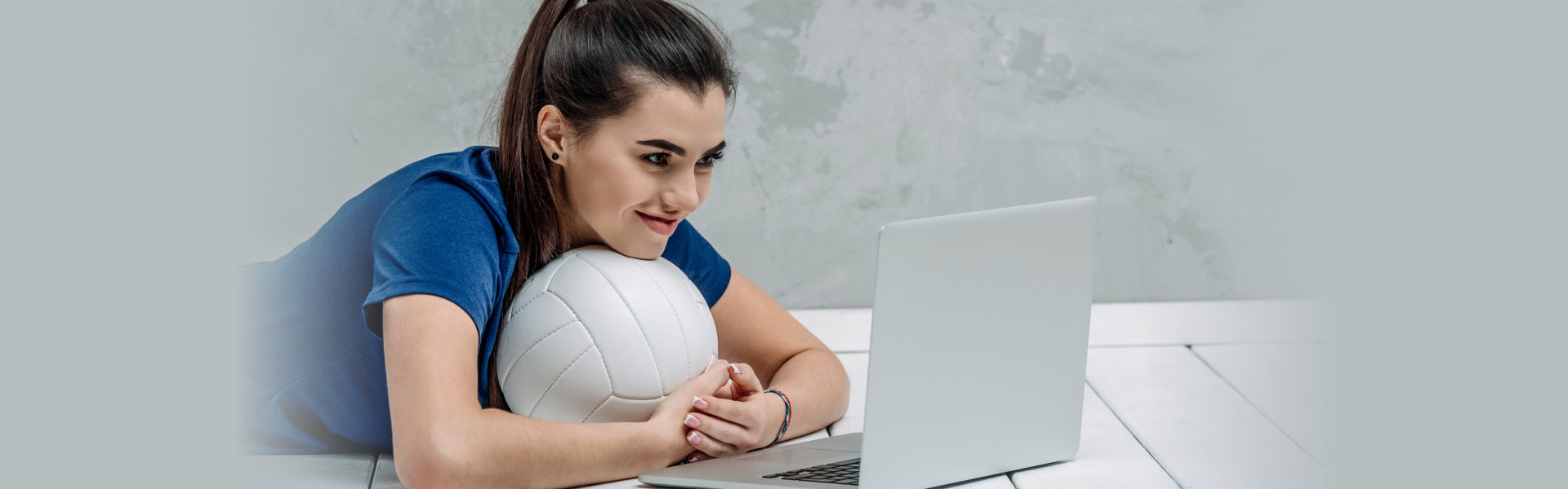 woman with volleyball using laptop