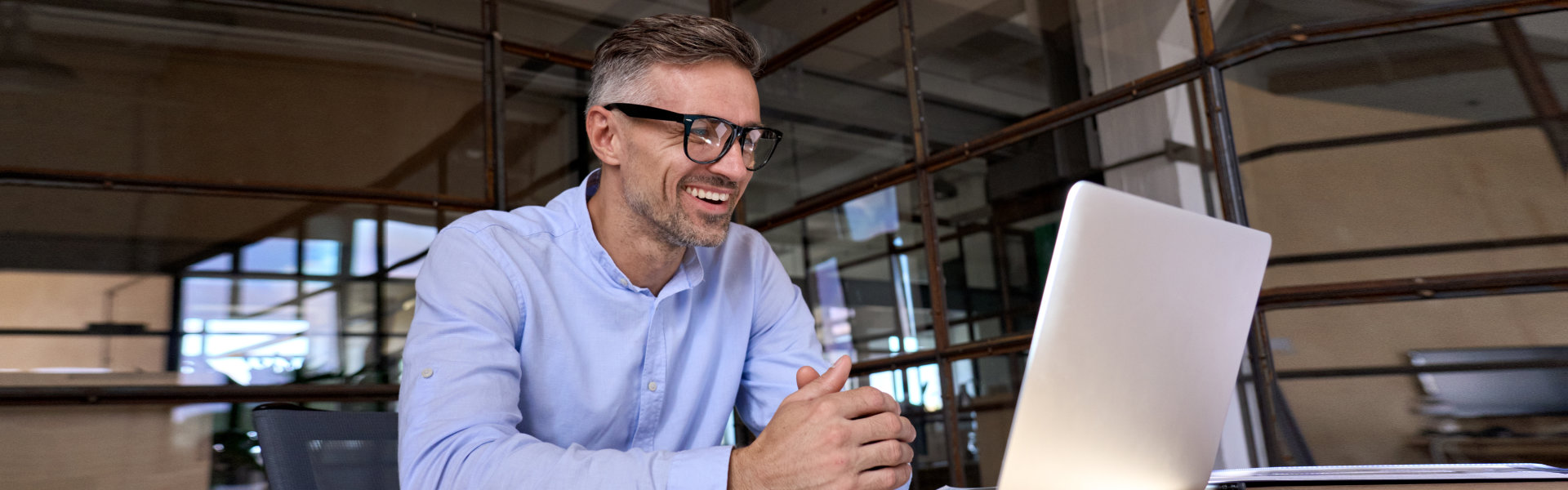 a person sitting at a desk with a laptop