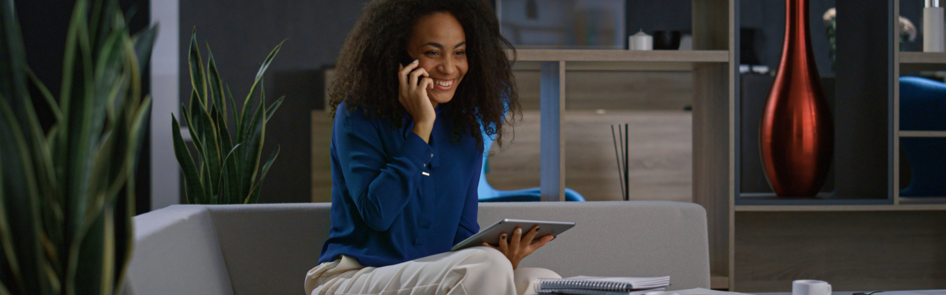 woman smiling while having a phone call