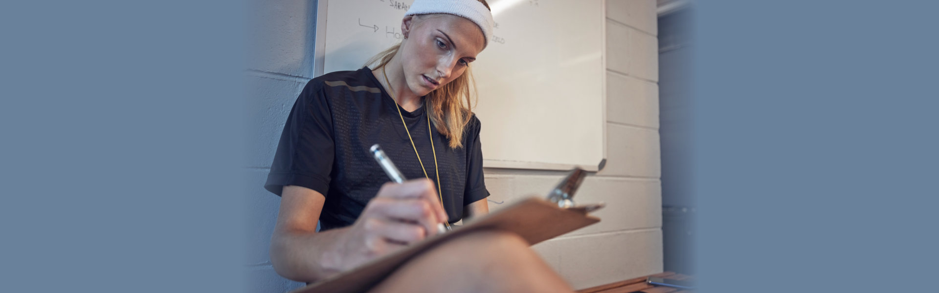 a person writing on a clipboard